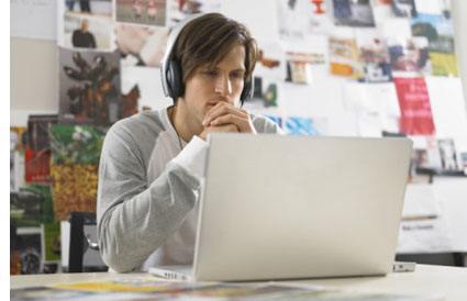 animator at laptop looking over his work