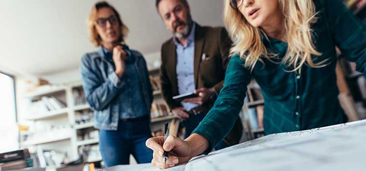 architect shows clients blueprint changes