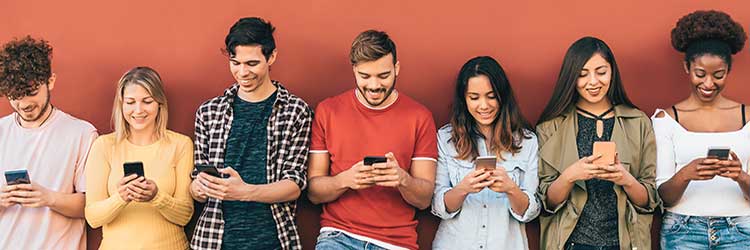 diverse group of people in a row all on smartphones